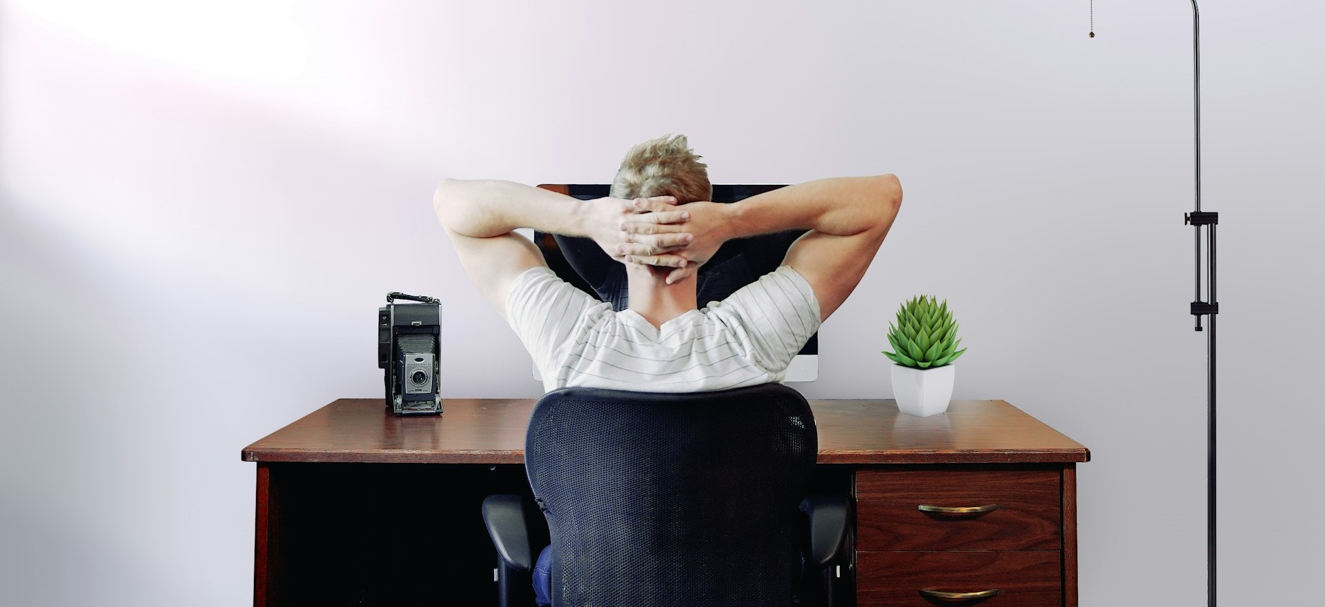 Stock photo of a person doing a quick stretch at their desk