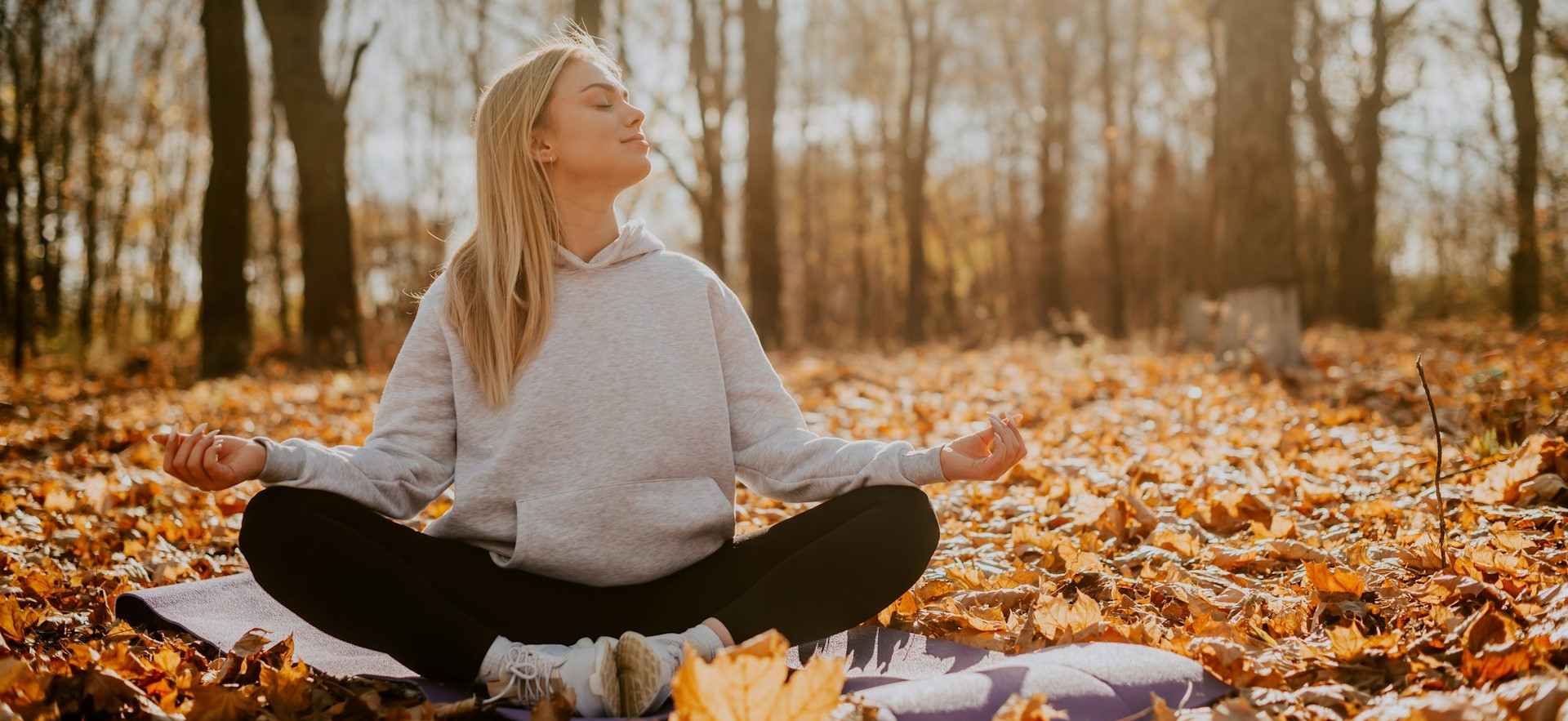 Stock photo of person meditating outdoors
