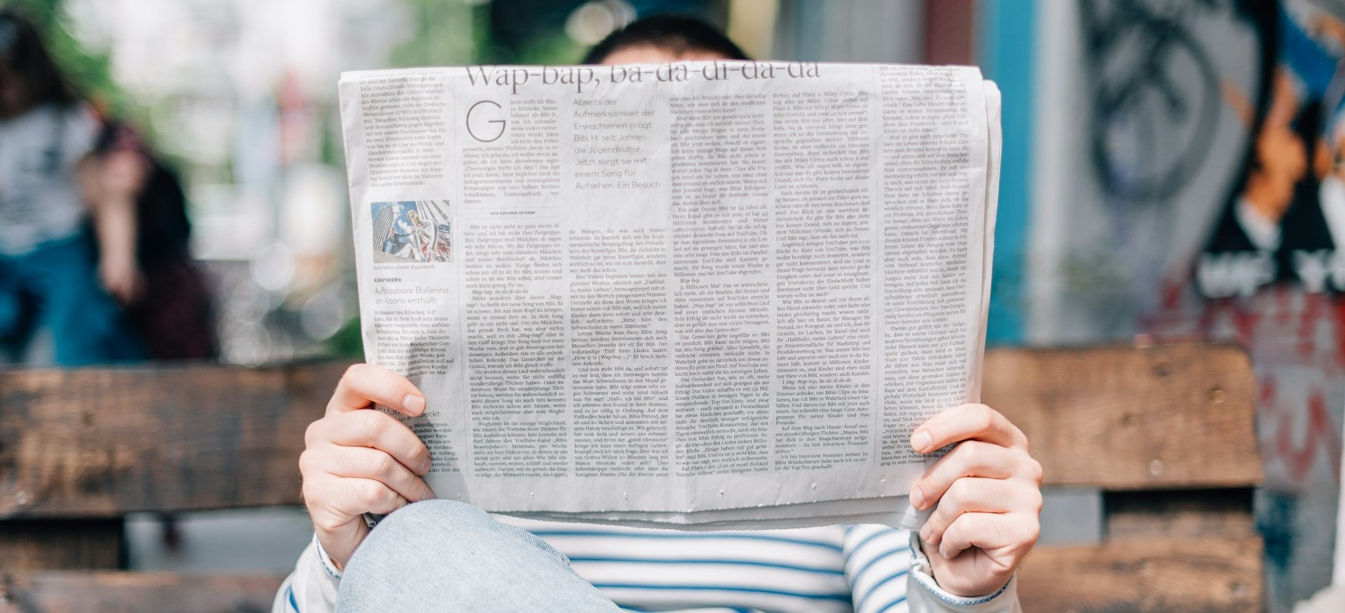 Stock photo of a person reading the newspaper